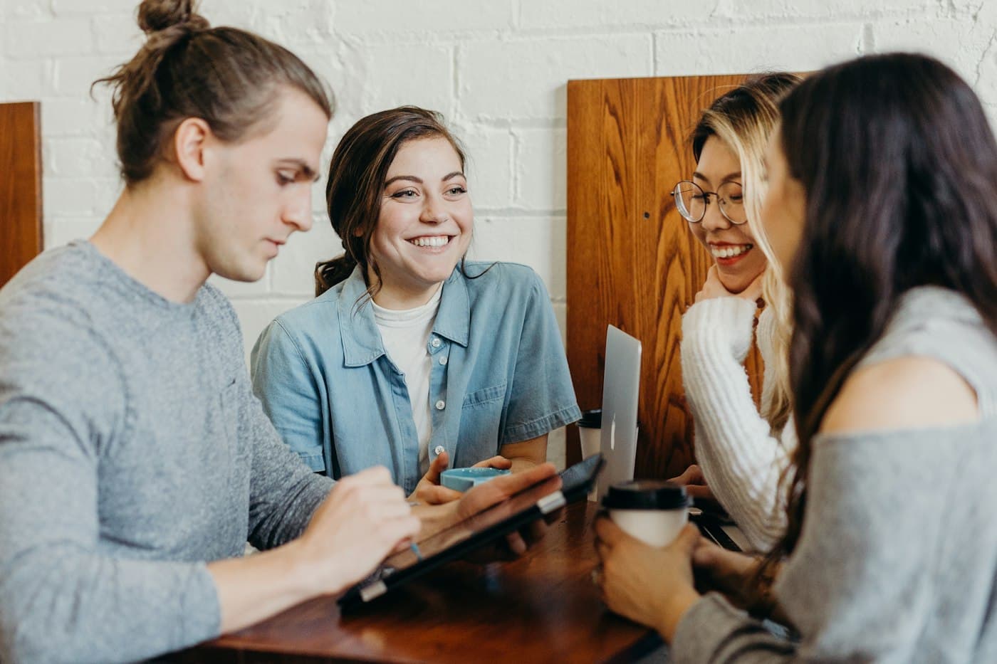 Learners laughing together while working on laptops